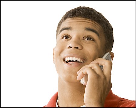 simsearch:640-02767760,k - Gros plan d'un jeune homme parlant sur un téléphone mobile Photographie de stock - Premium Libres de Droits, Code: 640-01358326