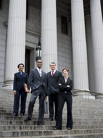 simsearch:640-02767805,k - Low angle view of lawyers standing on the steps of a courthouse Stock Photo - Premium Royalty-Free, Code: 640-01358355