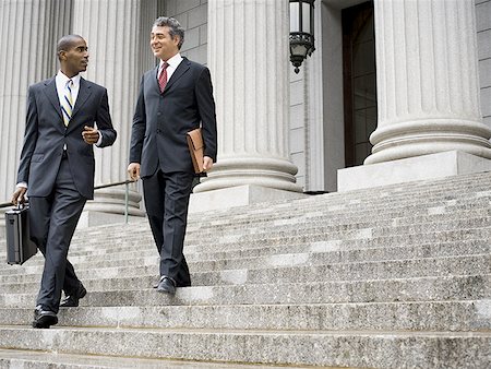 simsearch:655-03458001,k - Low angle view of two male lawyers talking on the steps of a courthouse Stock Photo - Premium Royalty-Free, Code: 640-01358367