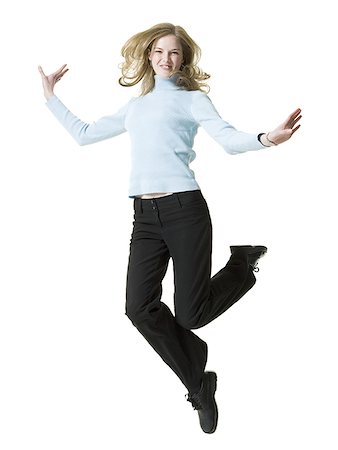 Portrait of a young woman jumping Stock Photo - Premium Royalty-Free, Code: 640-01358421