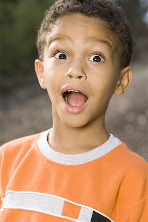 suprised african american kid - Portrait of a boy with his mouth open Stock Photo - Premium Royalty-Free, Code: 640-01358436