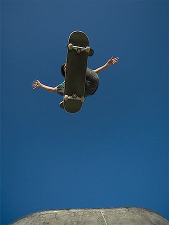 Low angle view of a person jumping with a skateboard Stock Photo - Premium Royalty-Free, Code: 640-01358443