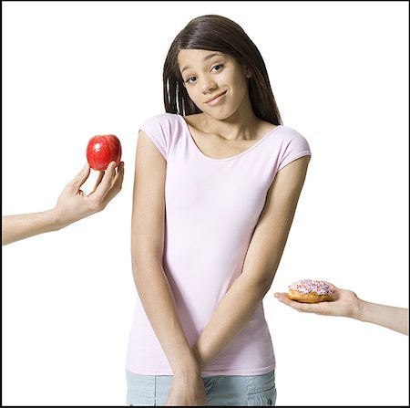 Close-up of two peoples hand's offering food to a girl Stock Photo - Premium Royalty-Free, Code: 640-01358478