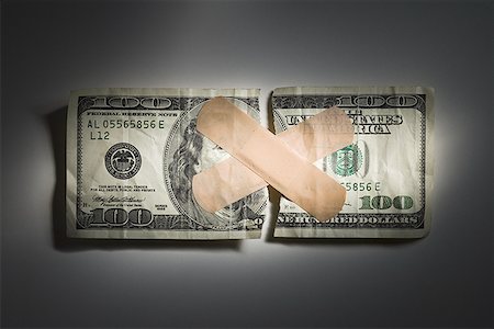 devalue - Torn US one hundred dollar bill with bandages Stock Photo - Premium Royalty-Free, Code: 640-01358488