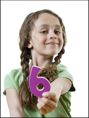 Portrait of a girl holding the number six Stock Photo - Premium Royalty-Free, Code: 640-01358480