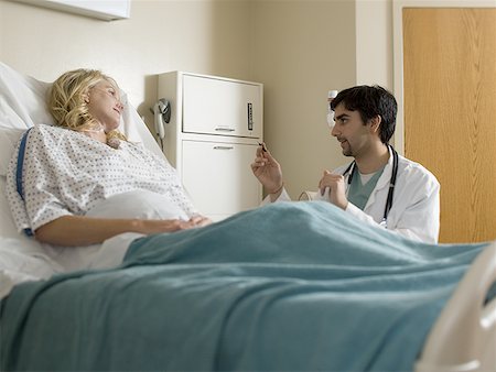 Male doctor talking to a female patient Stock Photo - Premium Royalty-Free, Code: 640-01358491