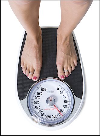 feet scale woman - Feet standing on a bathroom scale Stock Photo - Premium Royalty-Free, Code: 640-01358529