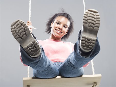 fashion face hair fun - Close-up of a teenage girl sitting on a swing Stock Photo - Premium Royalty-Free, Code: 640-01358582