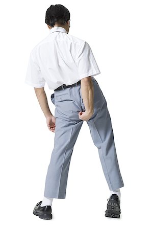 flaky - Rear view of a young man adjusting his pants Stock Photo - Premium Royalty-Free, Code: 640-01358604