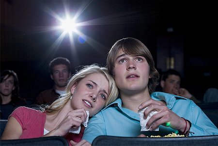 Boy and girl with tissues crying at movie theater Stock Photo - Premium Royalty-Free, Code: 640-01358769