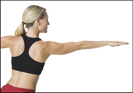 Rear view of a young woman stretching Stock Photo - Premium Royalty-Free, Code: 640-01358866