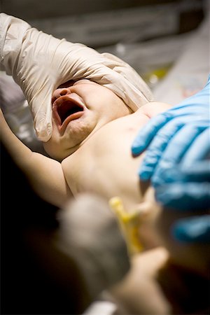 doctor and newborn baby - Doctor holding a newborn baby girl Stock Photo - Premium Royalty-Free, Code: 640-01359278