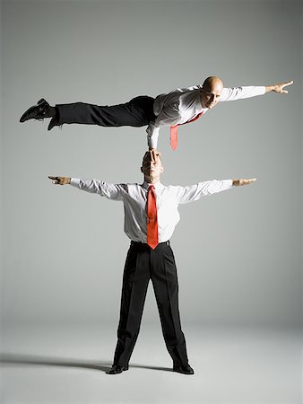 Two male acrobats in business suits Stock Photo - Premium Royalty-Free, Code: 640-01359387
