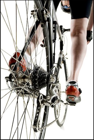 Low angle view of a man cycling Stock Photo - Premium Royalty-Free, Code: 640-01359433