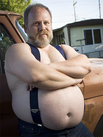 Overweight man with suspenders by truck Stock Photo - Premium Royalty-Free, Code: 640-01359483