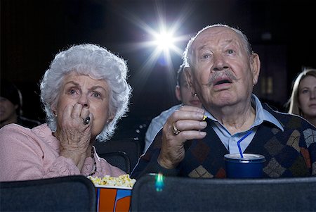 simsearch:640-02773406,k - Man and woman watching film at movie theatre frightened Stock Photo - Premium Royalty-Free, Code: 640-01359554