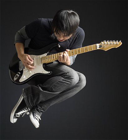 simsearch:640-01365707,k - Young man playing an electric guitar Stock Photo - Premium Royalty-Free, Code: 640-01359641
