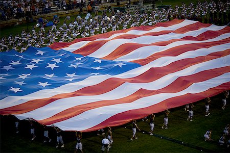 High angle view of a group of people holding a large American Flag Stock Photo - Premium Royalty-Free, Code: 640-01359643