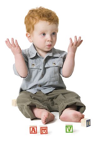 Baby boy sitting on the floor with building blocks Stock Photo - Premium Royalty-Free, Code: 640-01359832