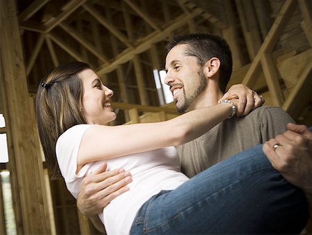 simsearch:640-02764709,k - Close-up of a young man carrying a young woman and smiling Stock Photo - Premium Royalty-Free, Code: 640-01359943