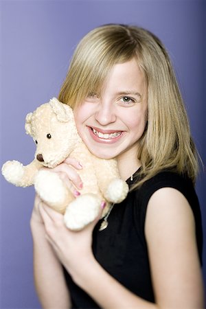 simsearch:400-04847852,k - Portrait of a girl holding a teddy bear Stock Photo - Premium Royalty-Free, Code: 640-01359985