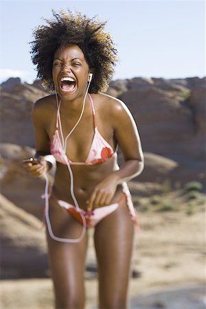simsearch:640-01358229,k - Young African-American woman listening to music Stock Photo - Premium Royalty-Free, Code: 640-01350166