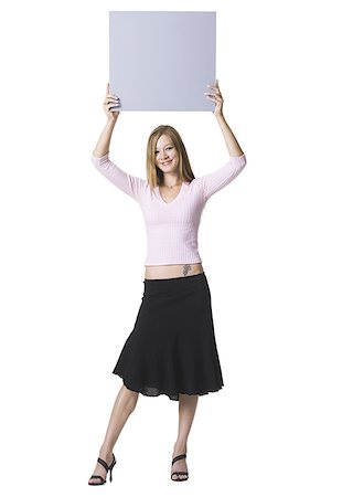 simsearch:640-01349238,k - Portrait of a young woman lifting up a blank sign Stock Photo - Premium Royalty-Free, Code: 640-01350376