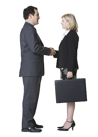 simsearch:640-03262464,k - Portrait of a businessman shaking hands with a businesswoman Stock Photo - Premium Royalty-Free, Code: 640-01350551
