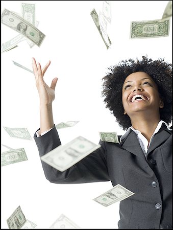 Close-up of a businesswoman throwing money into the air Stock Photo - Premium Royalty-Free, Code: 640-01350645