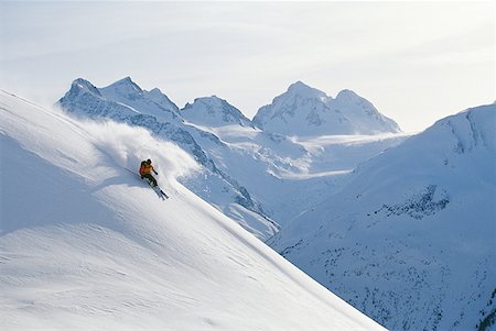 Downhill skier skiing on mountain Stock Photo - Premium Royalty-Free, Code: 640-01350897