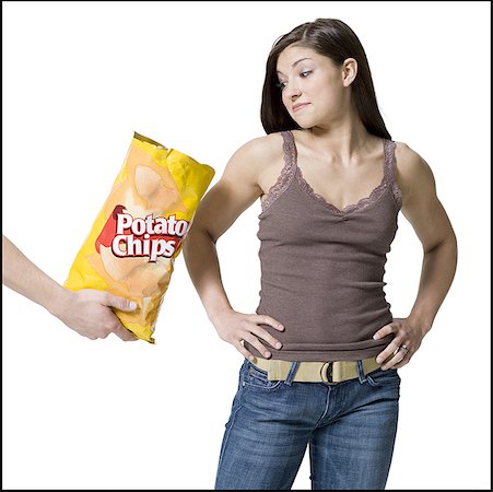 simsearch:700-02756413,k - Person offering potato chips to a young woman Stock Photo - Premium Royalty-Free, Code: 640-01350920
