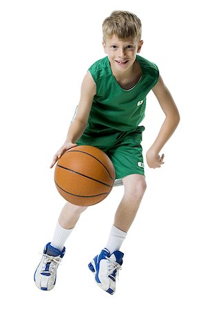 Young boy playing basketball Stock Photo - Premium Royalty-Free, Code: 640-01351013