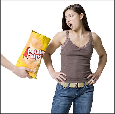 simsearch:700-02756413,k - Person offering potato chips to a young woman Stock Photo - Premium Royalty-Free, Code: 640-01351094