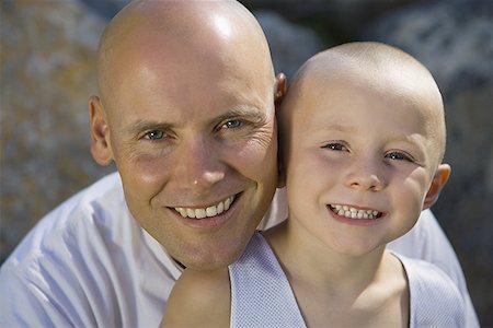 Portrait of a boy sitting on his father's lap Stock Photo - Premium Royalty-Free, Code: 640-01351154