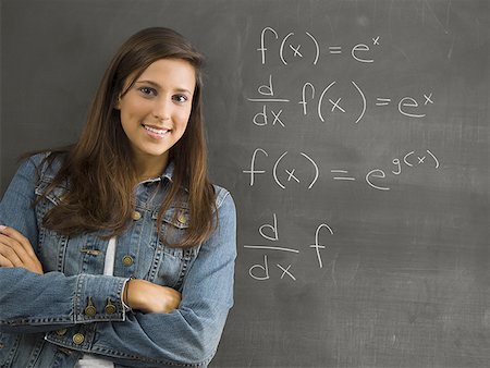 symbol for students education - Female student leaning against chalkboard Stock Photo - Premium Royalty-Free, Code: 640-01351227