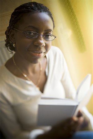 Portrait of a teenage girl holding a book Stock Photo - Premium Royalty-Free, Code: 640-01351303