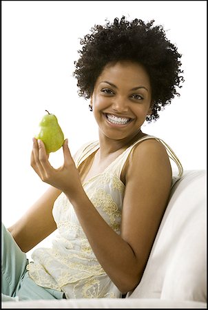 simsearch:640-01350537,k - Portrait of a young woman holding a pear Stock Photo - Premium Royalty-Free, Code: 640-01351365