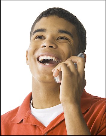 simsearch:640-02767760,k - Gros plan d'un jeune homme parlant sur un téléphone mobile et rire Photographie de stock - Premium Libres de Droits, Code: 640-01351474