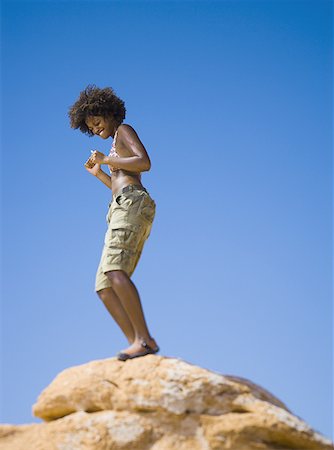 simsearch:640-01350537,k - Low angle view of a young woman dancing on a rock Stock Photo - Premium Royalty-Free, Code: 640-01351471