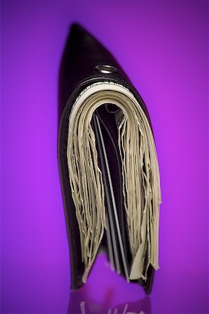 Close-up of a wallet crammed with paper currency Stock Photo - Premium Royalty-Free, Code: 640-01351482
