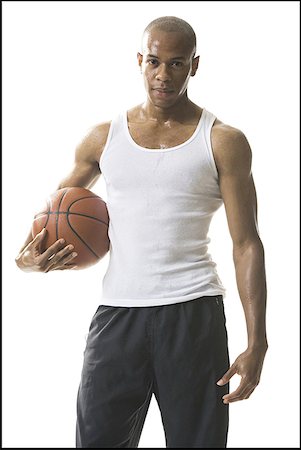 Portrait of a young man holding a basketball Stock Photo - Premium Royalty-Free, Code: 640-01351554