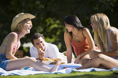 simsearch:640-02767388,k - Three young women with a young man enjoying in a park Stock Photo - Premium Royalty-Free, Code: 640-01351606