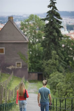 Rear view of a teenage couple walking on a path Stock Photo - Premium Royalty-Free, Code: 640-01351721