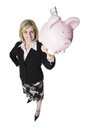 High angle view of a businesswoman holding up a piggy bank Stock Photo - Premium Royalty-Free, Code: 640-01351732