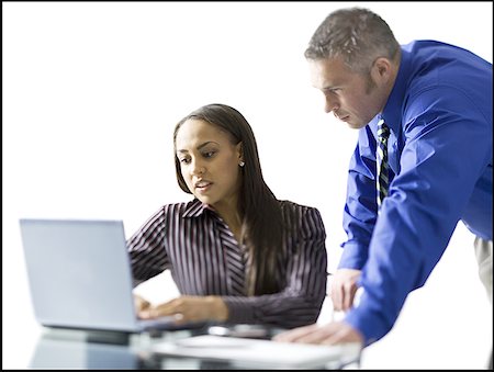 Businesswoman and a businessman working on a laptop Stock Photo - Premium Royalty-Free, Code: 640-01351856