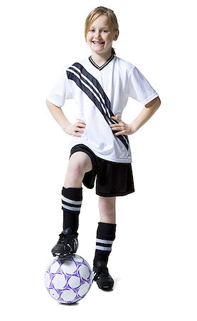 pantyhose kid - Portrait d'une jeune fille debout avec son pied sur un ballon de soccer Photographie de stock - Premium Libres de Droits, Code: 640-01351970