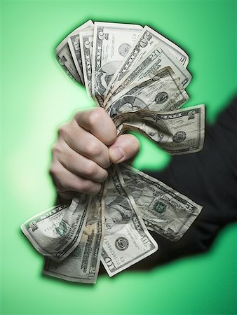 Close-up of a person's hand crushing paper currency Stock Photo - Premium Royalty-Free, Code: 640-01351997