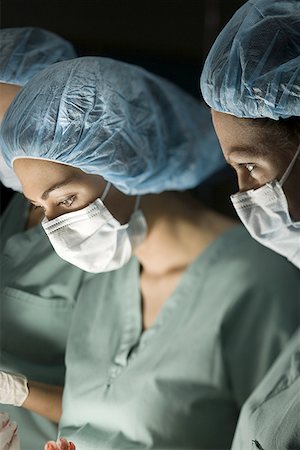 simsearch:640-01364042,k - Close-up of three female surgeons operating Stock Photo - Premium Royalty-Free, Code: 640-01352356