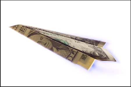 Close-up of a paper airplane made from a US dollar bill Stock Photo - Premium Royalty-Free, Code: 640-01352438