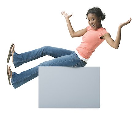 Portrait of a young woman sitting on a blank sign Stock Photo - Premium Royalty-Free, Code: 640-01352445